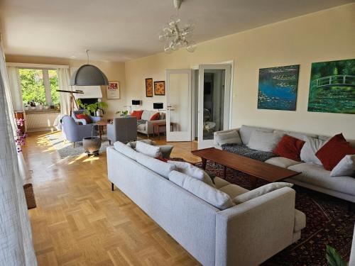 a living room with two couches and a table at Strandvillan i Slite in Slite