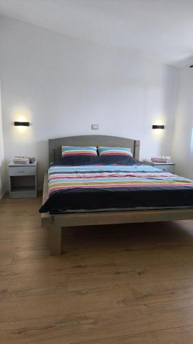 a bedroom with a large bed with two pillows at Apartments Sandra in Vrsar