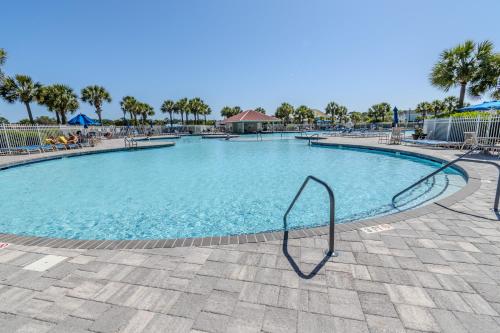 a large swimming pool with a metal rail in a resort at Havens on the Nine condo in North Myrtle Beach