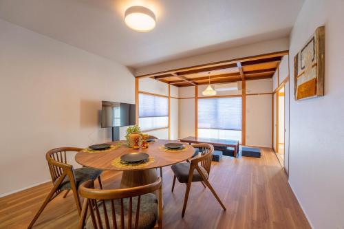 a kitchen and dining room with a table and chairs at Third Place Nagano in Matsumoto