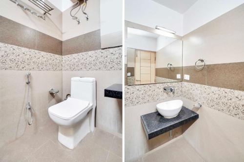 a bathroom with a toilet and a sink and a mirror at Townhouse Oak Durgapura Railway Junction in Jaipur