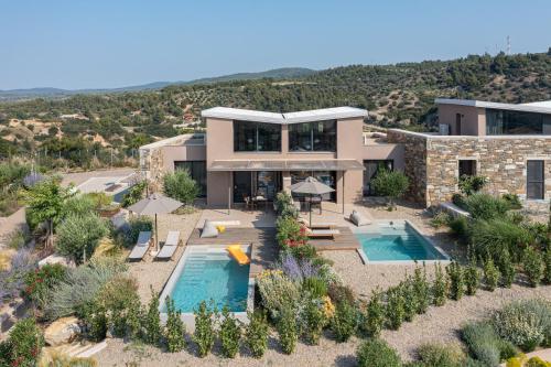 an aerial view of a house with two swimming pools at Etheres in Nikiti