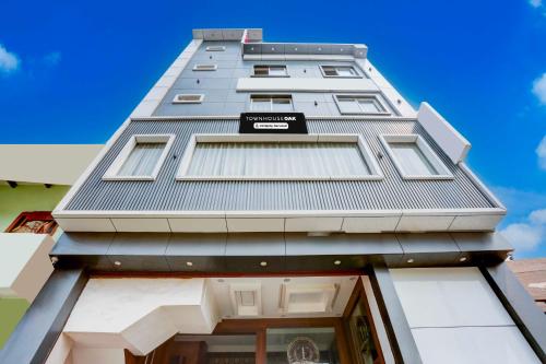 a tall building with a sign on the side of it at Townhouse Oak Model Town Rohtak in Rohtak