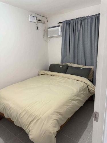 a bed in a small room with a window at JV tRansient 24 in Ormoc