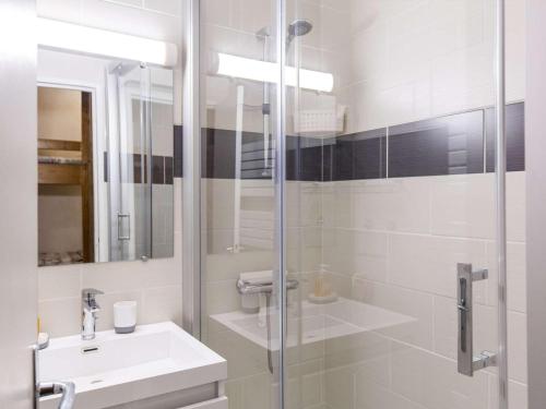 a white bathroom with a sink and a shower at Studio cabine au centre avec accès direct aux pistes - FR-1-400-101 in Eaux-Bonnes