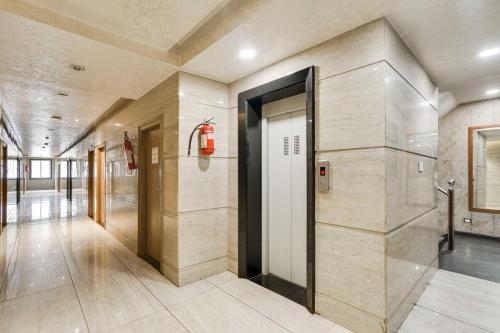 a hallway with a door in a building at Townhouse Oak Kota Airport in Kota