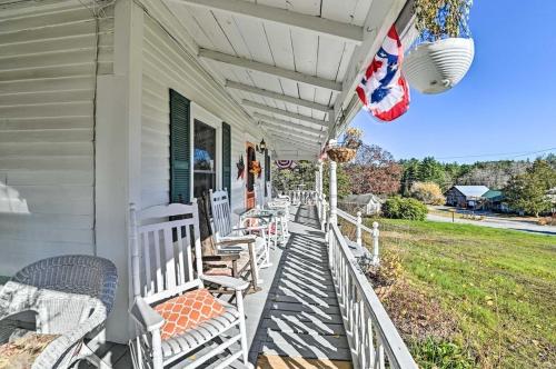 a porch of a house with chairs and an american flag at 10 Mi to Gore Mountain- Home in Adirondack Park home in Olmstedville