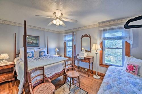 a bedroom with a bed with a fan and a desk at 10 Mi to Gore Mountain- Home in Adirondack Park home in Olmstedville