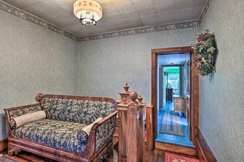 a living room with a couch and a mirror at 10 Mi to Gore Mountain- Home in Adirondack Park home in Olmstedville
