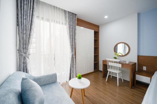 a living room with a couch and a table at Samatha Apartment & Hotel in Da Nang