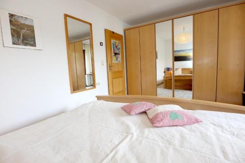 a bedroom with a bed with two pillows on it at Gemütliche Fewo mit Sonnenterrasse in Bernau im Schwarzwald