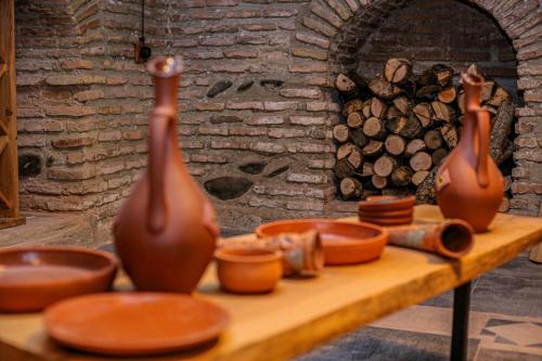 two vases sitting on a table next to a fireplace at Dzvel Ubanshi in Gori