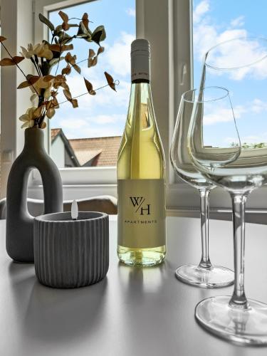 a bottle of wine and two glasses on a table at Modernes Apartment 'Ulla' in Diepholz in Diepholz