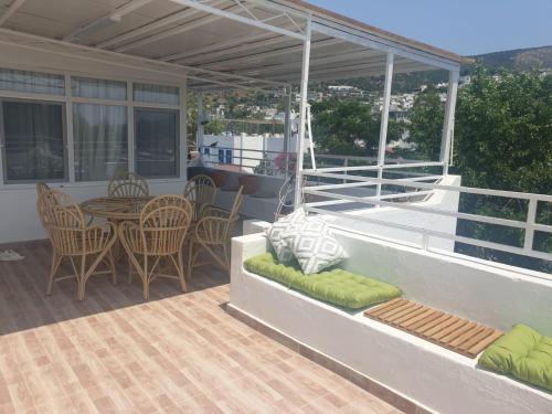 a patio with a table and chairs on a balcony at Kavala Hotel Bodrum in Bodrum City