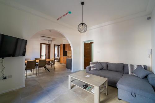 a living room with a couch and a table at Flora Flats 1st, 2nd and 3rd floor appartments no lift in St Paul's Bay