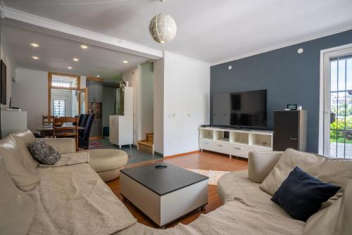 a living room with a couch and a tv at Capital Stay in Sarajevo