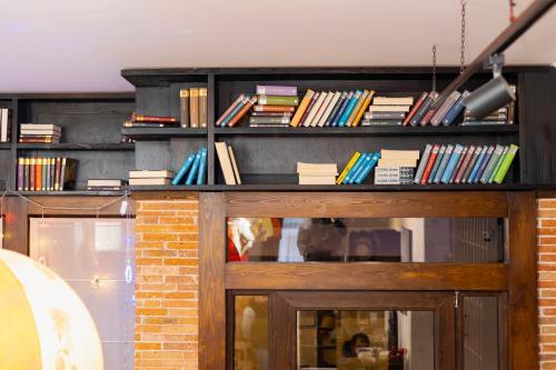 a book shelf with a lot of books on it at Dzvel Ubanshi in Gori