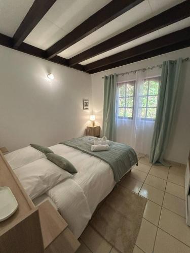a bedroom with a large bed and a window at T4 cosy au cœur de Salazie in Salazie