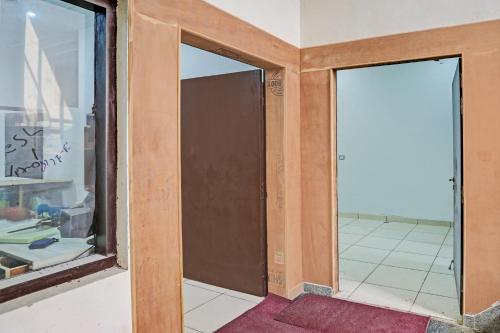 two glass doors in a room with a tile floor at Super Hotel O Park Inn Near Parashuram Chowk in Morādābād