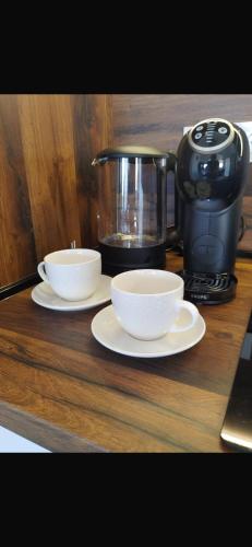 a counter with two bowls and a coffee pot on it at Bella Vista Sunset penthouse with private jacuzzi in Novalja