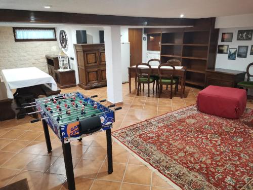 a room with a chess table and a living room at Villa Relax&Fly near Malpensa with Pool in Sumirago