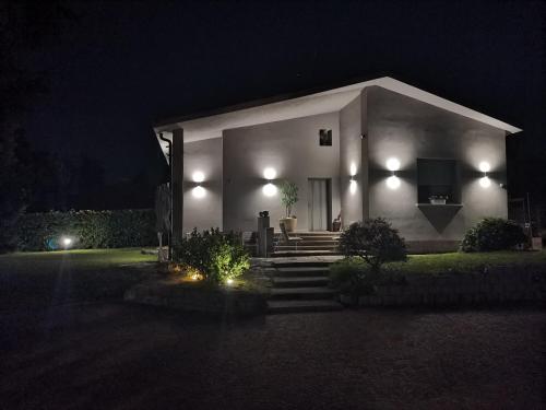 a white house at night with lights on it at Villa Relax&Fly near Malpensa with Pool in Sumirago