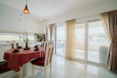a dining room with a table with a red table cloth at Mahakala Center in Petrovac na Moru