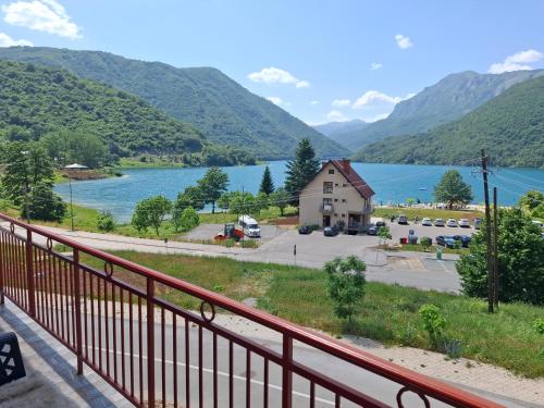 a view of a lake from a balcony at Apartment Osmajic in Pluzine
