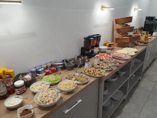 a buffet with many plates of food on a table at Rezydencja Widokowa in Bukowina Tatrzańska