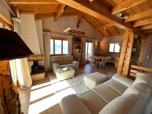 a large living room with couches and a table at Chalet Fava in Plan Fey