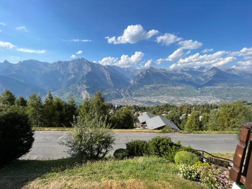a view of a mountain range from a road at Chalet Fava in Plan Fey