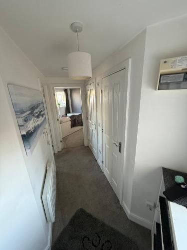 a room with a hallway with a door and a bedroom at Stylish Marina Apartment with Stunning Views in Portishead