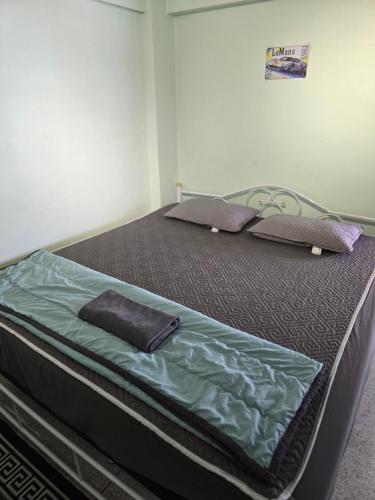 a bed with two pillows on it in a room at 812 Quiet AC Apartment with Balcony & free Wifi in Bangkok