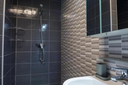 a bathroom with a shower and a sink at Sixties Elite Free Private Parking in Debrecen
