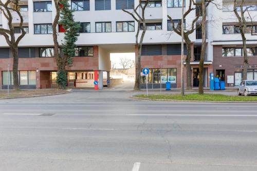 an empty street in front of a building at Sixties Elite Free Private Parking in Debrecen