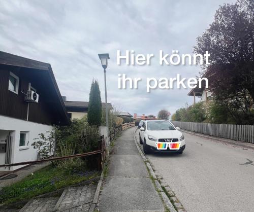 a white car parked on the side of a road at Room with a Skylight - gemütliches Zimmer zwischen München und Rosenheim in Feldkirchen-Westerham