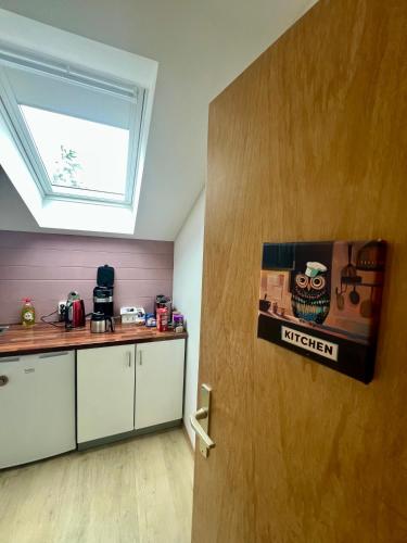a kitchen with a door with a sign on it at Room with a Skylight - gemütliches Zimmer zwischen München und Rosenheim in Feldkirchen-Westerham