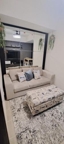 a living room with a couch and a rug at House of Lilith at Kasara in Manila