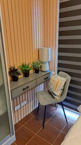a bedroom with a desk with a chair and plants at House of Lilith at Kasara in Manila