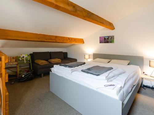 une chambre avec un grand lit et un canapé dans l'établissement Studio mezzanine avec terrasse, piscine & parking à proximité de la plage - Narbonne - FR-1-409-241, à Narbonne