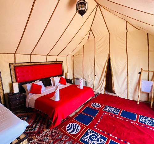 a bedroom with two beds in a tent at Outdoor luxury camp in Merzouga