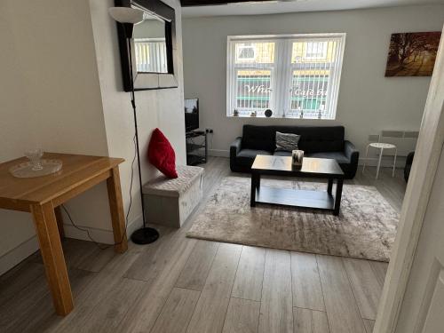 a living room with a couch and a table at Sowerby Apartment in Sowerby Bridge