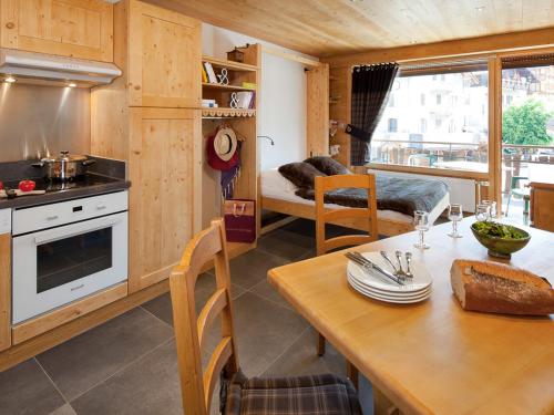 une cuisine avec une table et une salle à manger dans l'établissement Charmant studio montagnard avec accès bien-être, proche centre et pistes de ski au Grand-Bornand - FR-1-467-37, au Grand-Bornand