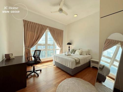 a bedroom with a bed and a desk and windows at Tritower Near CIQ Johor Bahru by JCHOME MWM in Johor Bahru