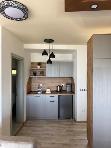a kitchen with white cabinets and a counter top at Velestovo Panorama House in Velestovo