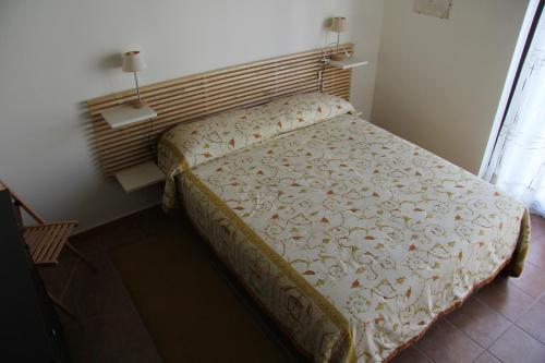 Ένα ή περισσότερα κρεβάτια σε δωμάτιο στο Soleado Apartment - Un sogno tra le meraviglie di Marinagri