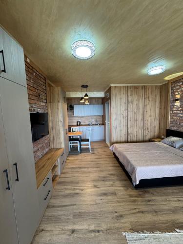 a bedroom with a bed and a kitchen at Velestovo Panorama House in Velestovo