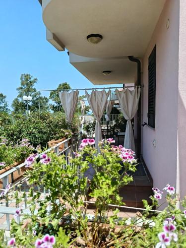 a balcony of a house with pink flowers at L’altra Sicilia…da Amare in Acquedolci