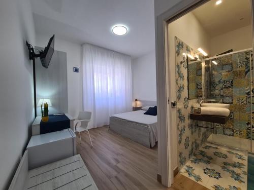 a bedroom with a bed and a bathroom with a shower at B&B testa di Moro in Giarre