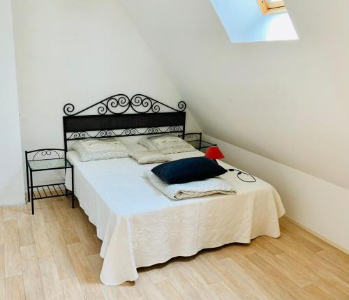 a bedroom with a bed with a black headboard at L'écluse appartement vue sur mer in Port-en-Bessin-Huppain